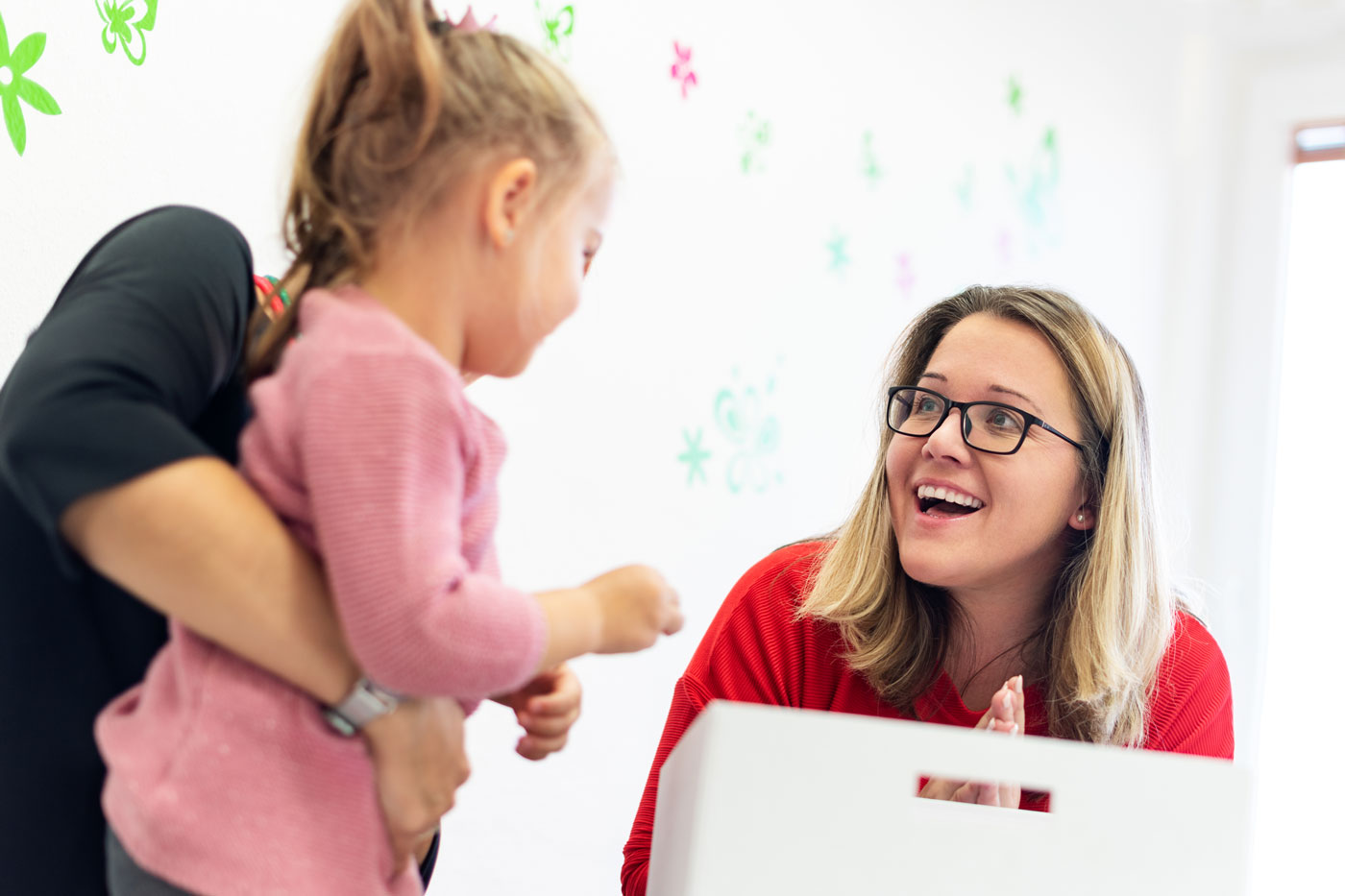 Young girl and teacher smiling