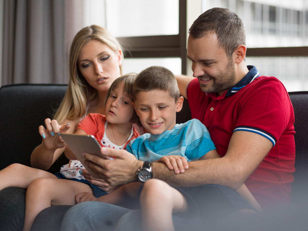 Stock image of a family on sofa at home